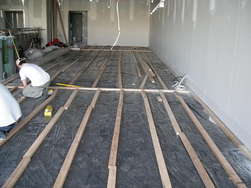 Hardwood battens being fixed over a moisture barrier